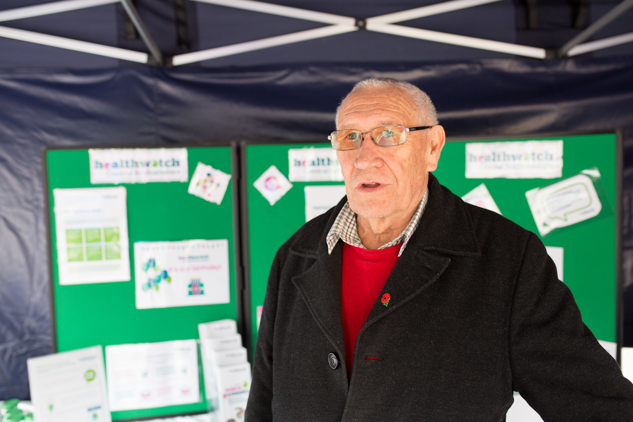 Male volunteer promoting Healthwatch at an event